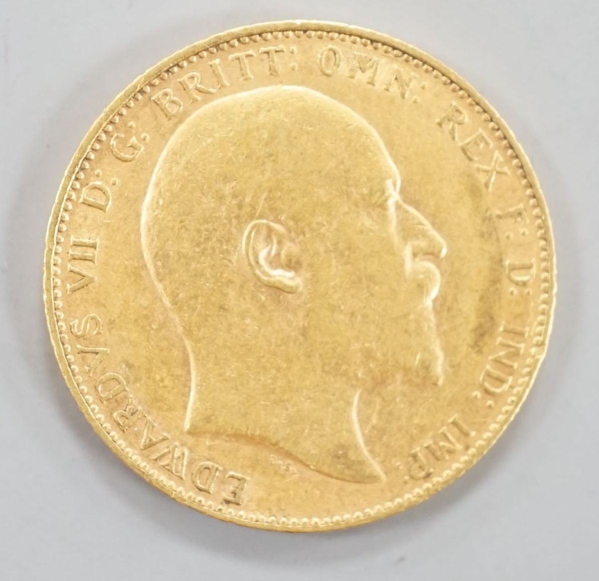 A George V 1910 gold sovereign.